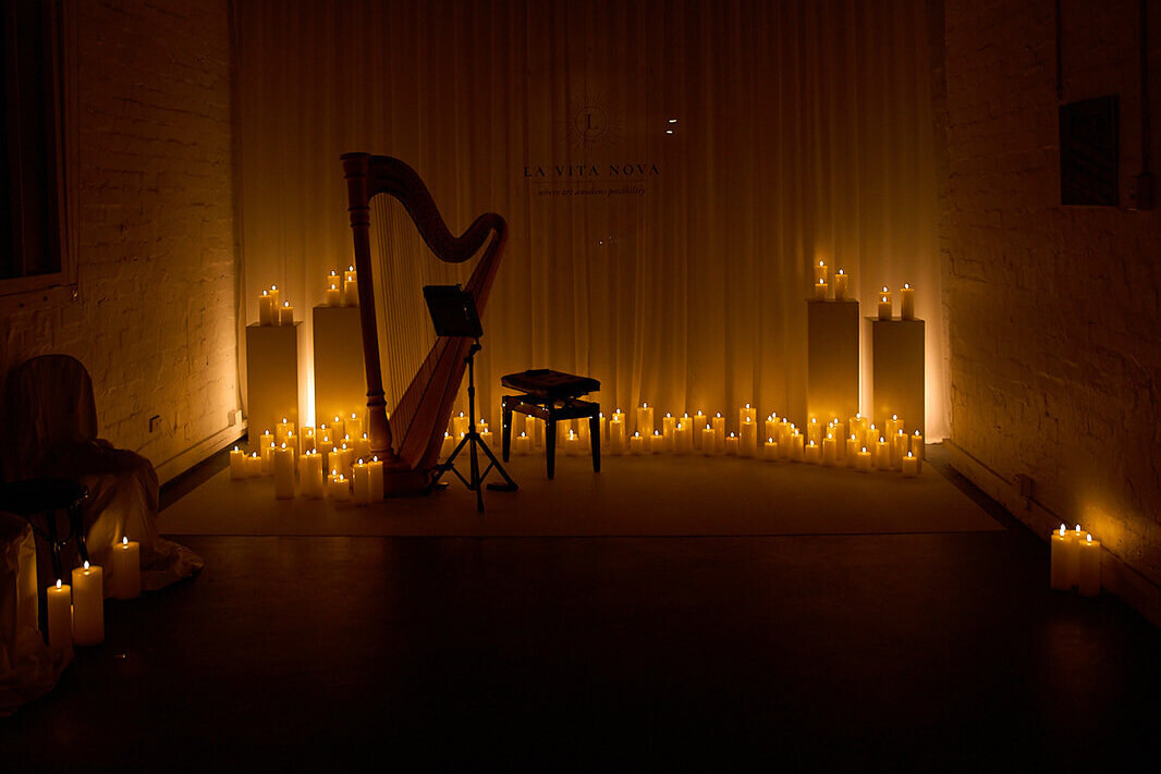 The candlelit harp room at La Vita Nova, lined with pillar candles