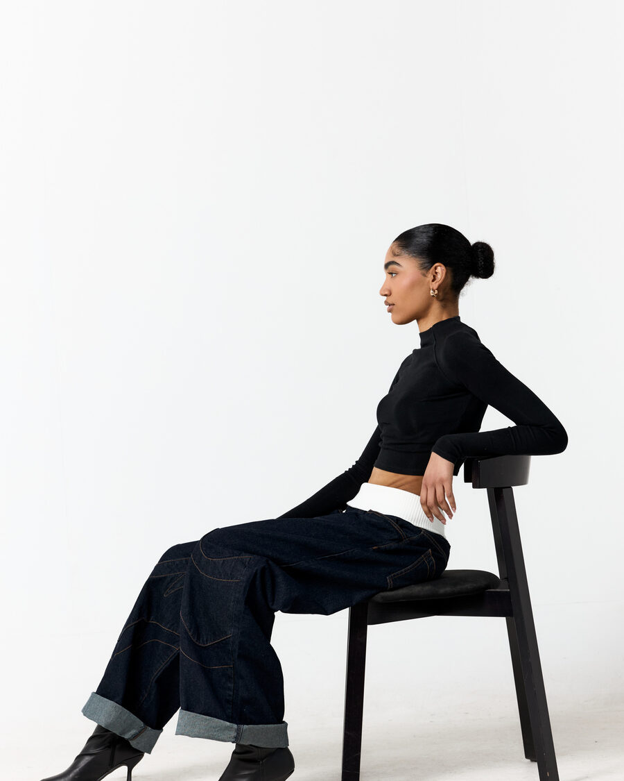 A seated portrait against a white backdrop, shot in the studio at La Vita Nova